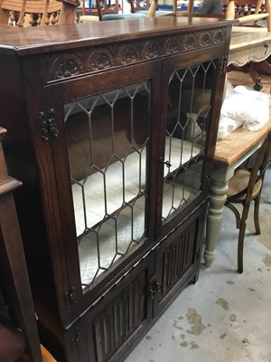 Lot 923 - Old charm style carved oak display cabinet with leaded glazed doors and linen fold doors below 99 cm wide