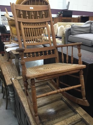 Lot 927 - Edwardian oak rocking elbow chair with caned seat and turned back