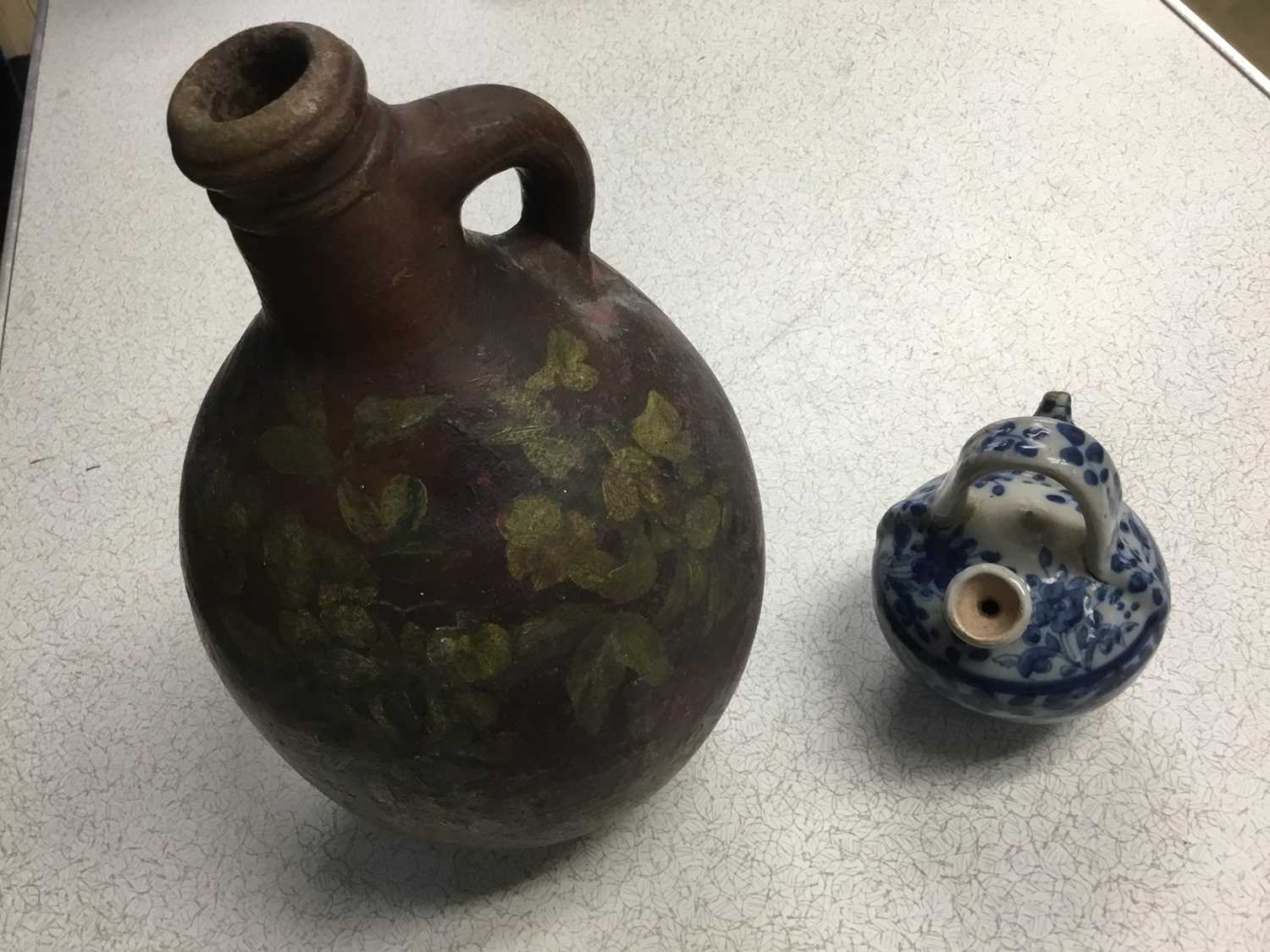 Lot 176 - Antique Continental blue and white jar, retailers label to base, together with an 18th century  salt glazed  flagon, with painted ornament