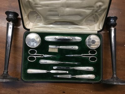 Lot 668 - Silver mounted manicure set in original fitted case, Birmingham 1918, together with a pair of silver candlesticks