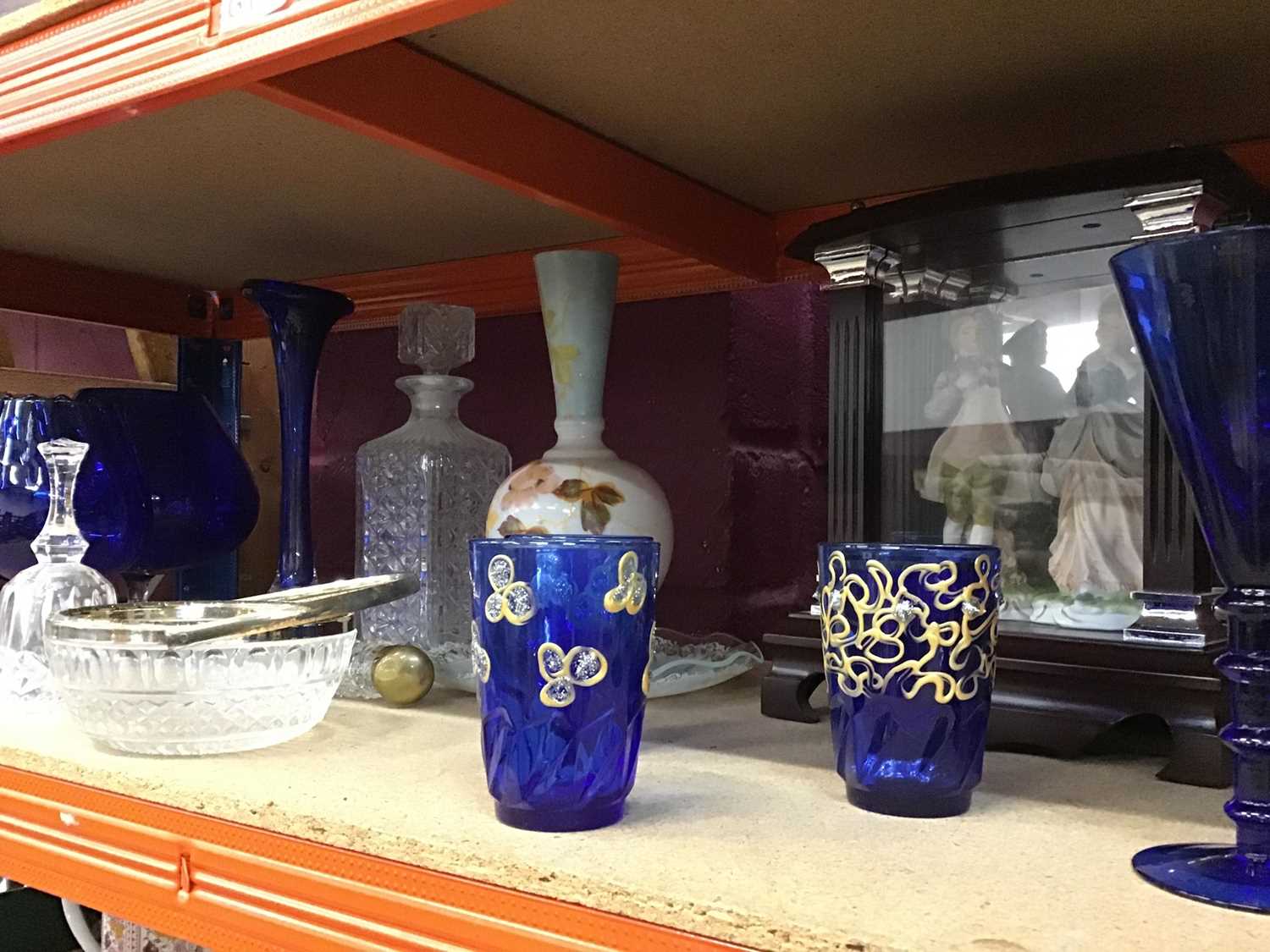 Lot 555 - Selection of Colbolt blue glass ware and other glass with display cabinet and two enclosed china figurienes