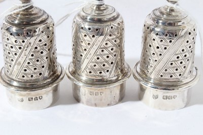 Lot 77 - Trio of George V silver pepperettes in the Georgian style with engraved crests (London 1915), all at 7ozs
