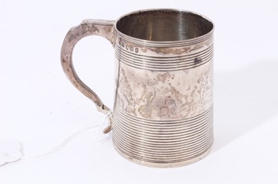 Lot 23 - George III silver christening mug of tapered form with ribbed bands and loop handle (London 1803), 5ozs