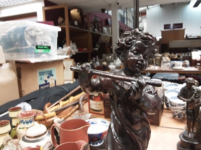 Lot 281 - Spelter figural table lamp in the form of a girl playing the flute with amber glass shade
