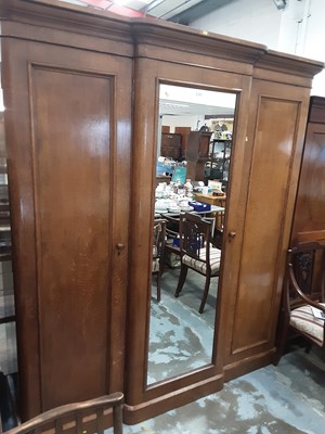 Lot 1024 - Victorian oak triple wardrobe with central mirrored door flanked by two panelled doors