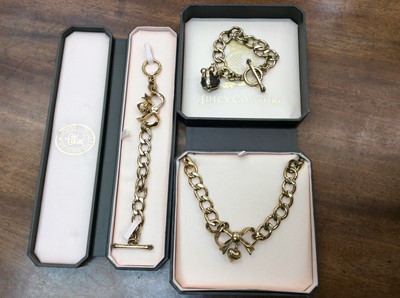 Lot 706 - Juicy Couture gilt metal necklace and matching bracelet with bow and heart decoration and one other bracelet with heart charm