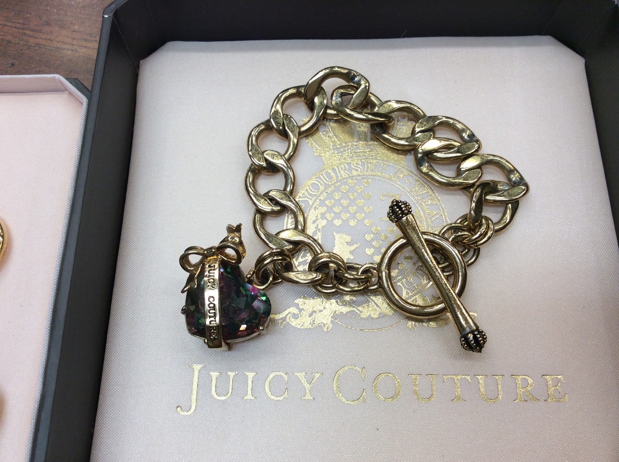 Juicy Couture gilt metal necklace and matching bracelet with bow