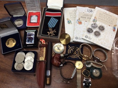 Lot 713 - Various watches, coins including Beatrix Potter 50p coins, lighters and sundries