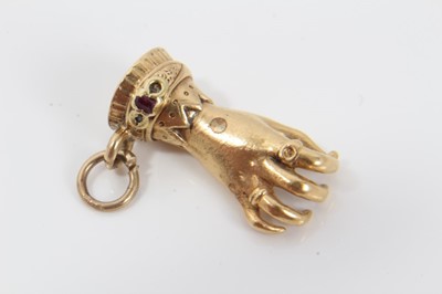 Lot 299 - 19th Yellow metal charm in the form of a hand, set with rubies