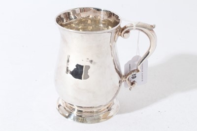 Lot 239 - George II silver tankard of baluster form with scroll handle, on a circular foot, (London 1748), maker William Shaw and William Priest, all at approximately 9oz, 12cm in overall height