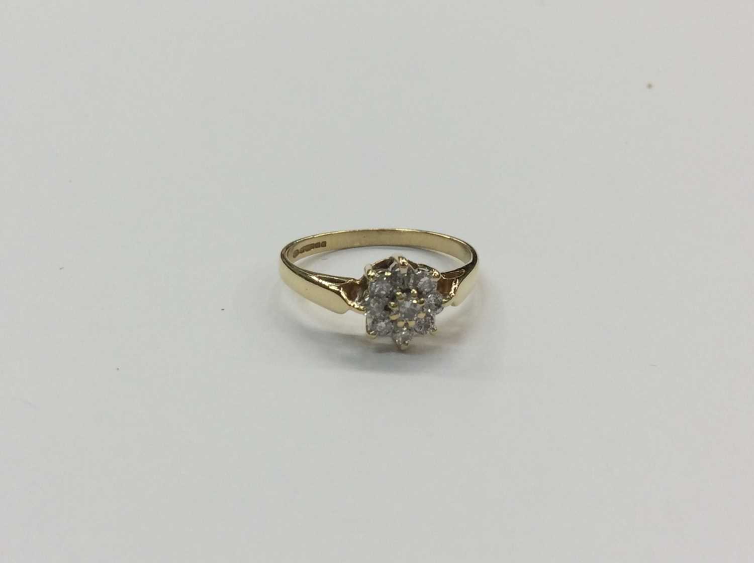 Lot 654 18ct gold diamond flower head cluster ring