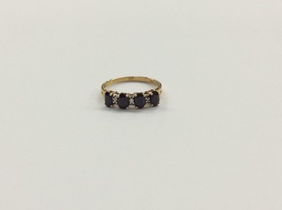 Lot 702 - 9ct gold sapphire four stone ring