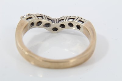 Lot 21 - 9ct gold diamond seven stone wishbone ring