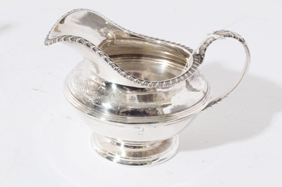 Lot 29 - George V silver and silver plated composite four piece tea and coffee set- comprising teapot of compressed baluster form, hinged domed cover, angular ebony handle, raised on four ball feet