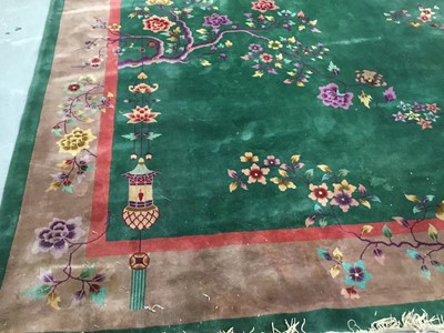 Lot 870 - Chinese washed carpet on green ground with lantern and floral decoration