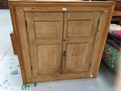 Lot 857 - 19th century stripped pine hanging corner cupboard with two panelled doors enclosing shaped shelves 112 cm wide, 115 cm high