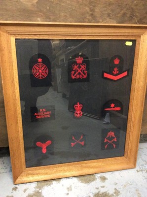 Lot 472 - Royal Navy cloth badges mounted in two glazed frames