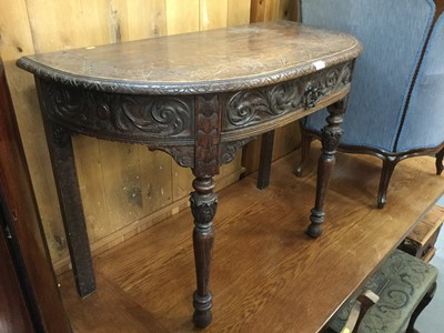 Lot 1062 - Late Victorian Carved oak Demi lune hall table with drawer