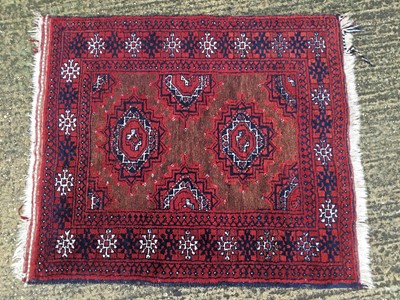 Lot 867 - An old Afghan rug on red and blue ground, 104cm x 119cm