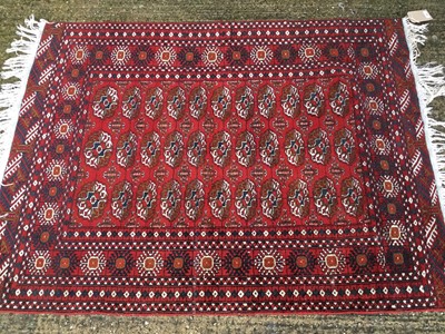 Lot 868 - An old Bokhara rug on red and blue ground, 188cm x 124cm