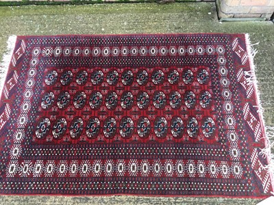 Lot 869 - An old Bokhara rug on red and blue ground, 167cm x 126cm