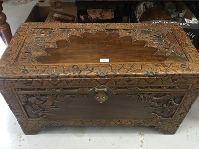 Lot 876 - Contemporary Chinese carved camphor wood trunk with decorative figure and landscape panels, on bracket feet