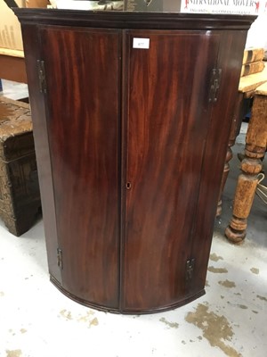 Lot 877 - George III inlaid mahogany barrel front hanging corner cupboard with shelved interior