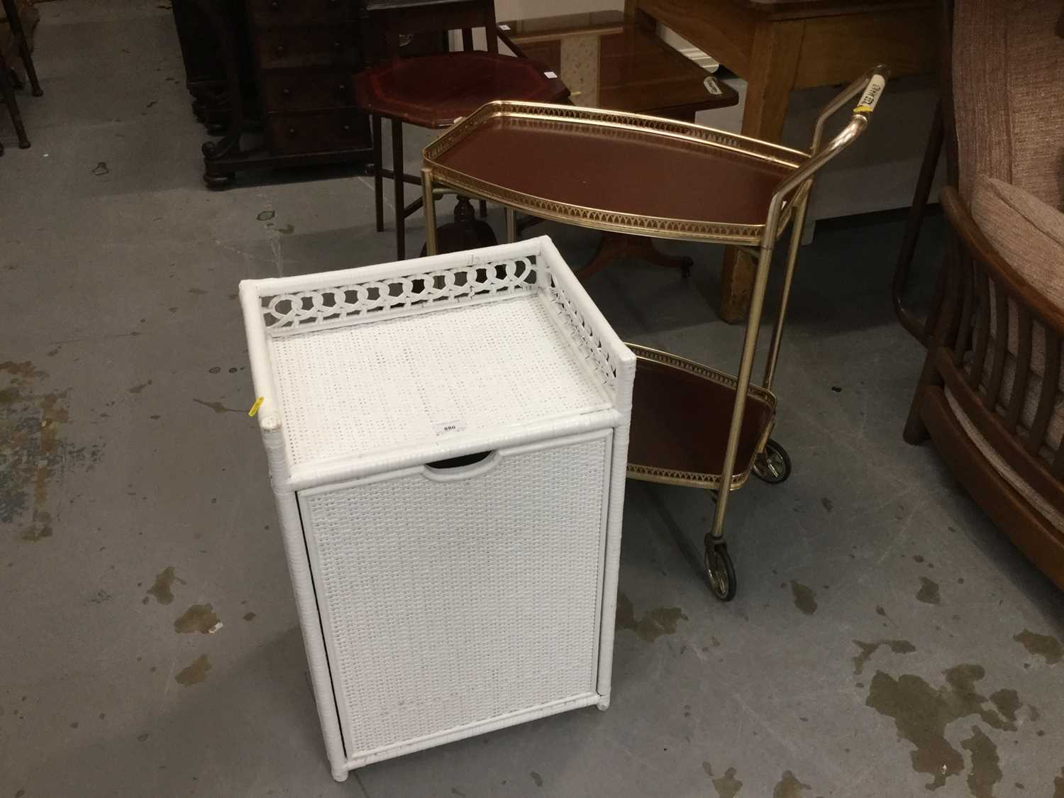 Lot 880 - Lloyd Loom style white painted laundry basket together with a two tier tea trolley (2)