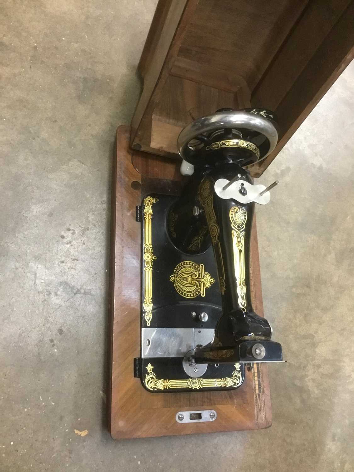 Lot 203 - Antique hand sewing machine in walnut case