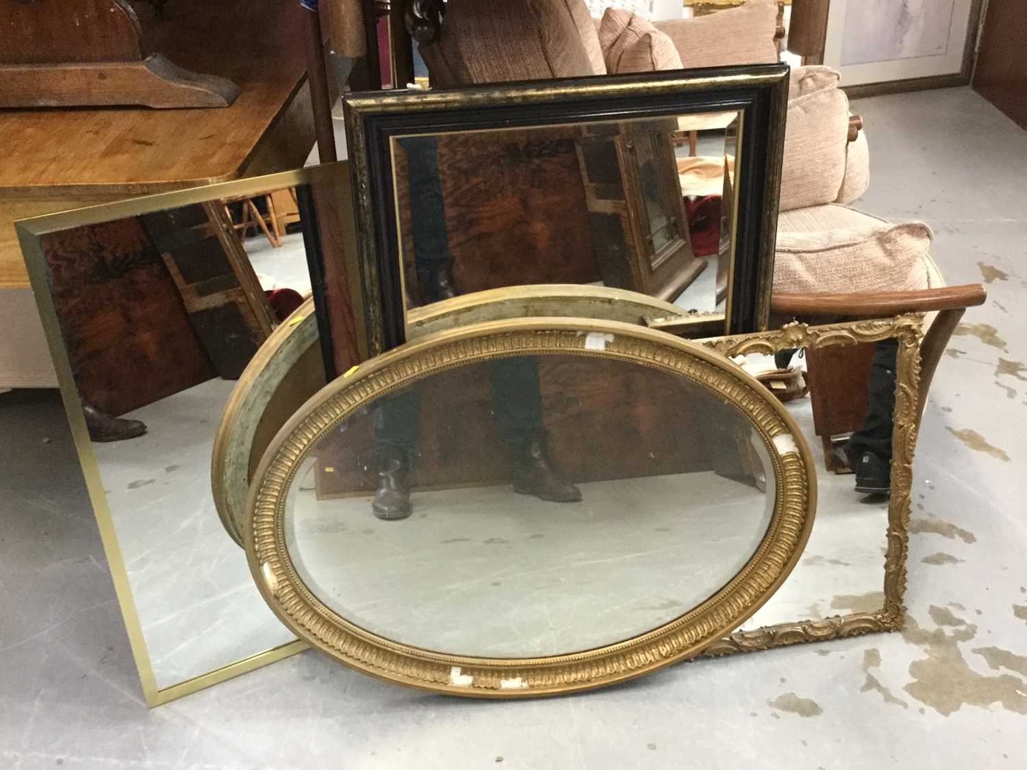 Lot 114 - Oval gilt framed bevelled wall mirror together with three other wall mirrors (4)
