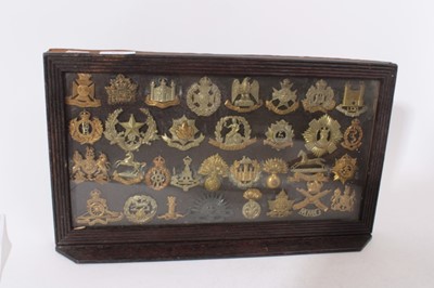 Lot 252 - Group of First World War Military cap badges mounted in a glazed frame