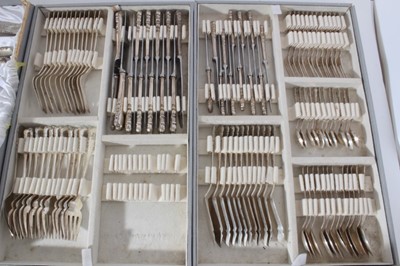 Lot 230 - Extensive part canteen of silver cutlery with decorative scroll borders and engraved initials, comprising,  12, fish forks, 12 fish knives, 12 dinner forks, 12 dinner
