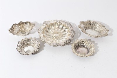 Lot 20 - Pair of late Victorian silver embossed pin dishes (Sheffield 1895), two other pierced silver dishes and an Edwardian silver dish with pierced and embossed foliate borders, all at 6.1ozs, (5)