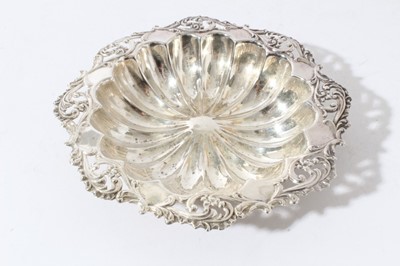 Lot 20 - Pair of late Victorian silver embossed pin dishes (Sheffield 1895), two other pierced silver dishes and an Edwardian silver dish with pierced and embossed foliate borders, all at 6.1ozs, (5)