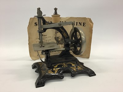 Lot 1879 - Miniature German  sewing machine and original instructions