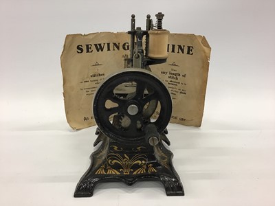 Lot 1879 - Miniature German  sewing machine and original instructions