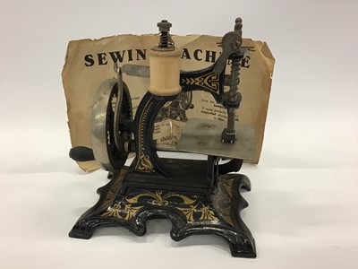 Lot 1879 - Miniature German  sewing machine and original instructions