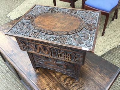 Lot 1006 - Oriental heavily carved hardwood folding stool depicting Dragons amongst flowers and characters