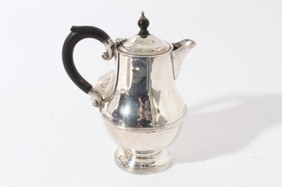 Lot 46 - George V silver hot water pot of baluster form with ebony finial and loop handle (Birmingham 1931), maker Marson & Jones, all at 11.8ozs, 18.5cm in height