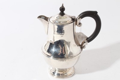 Lot 46 - George V silver hot water pot of baluster form with ebony finial and loop handle (Birmingham 1931), maker Marson & Jones, all at 11.8ozs, 18.5cm in height