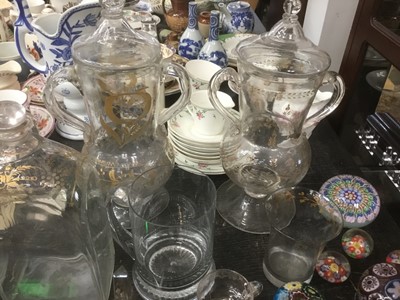 Lot 178 - Decorative collection of glass including 18th century Dutch gilt ornamented flasks and loving cups, obelisk desk stands and paperweights