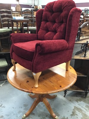 Lot 963 - Contempory wing easy chair with red upholstery and pine circular breakfast table