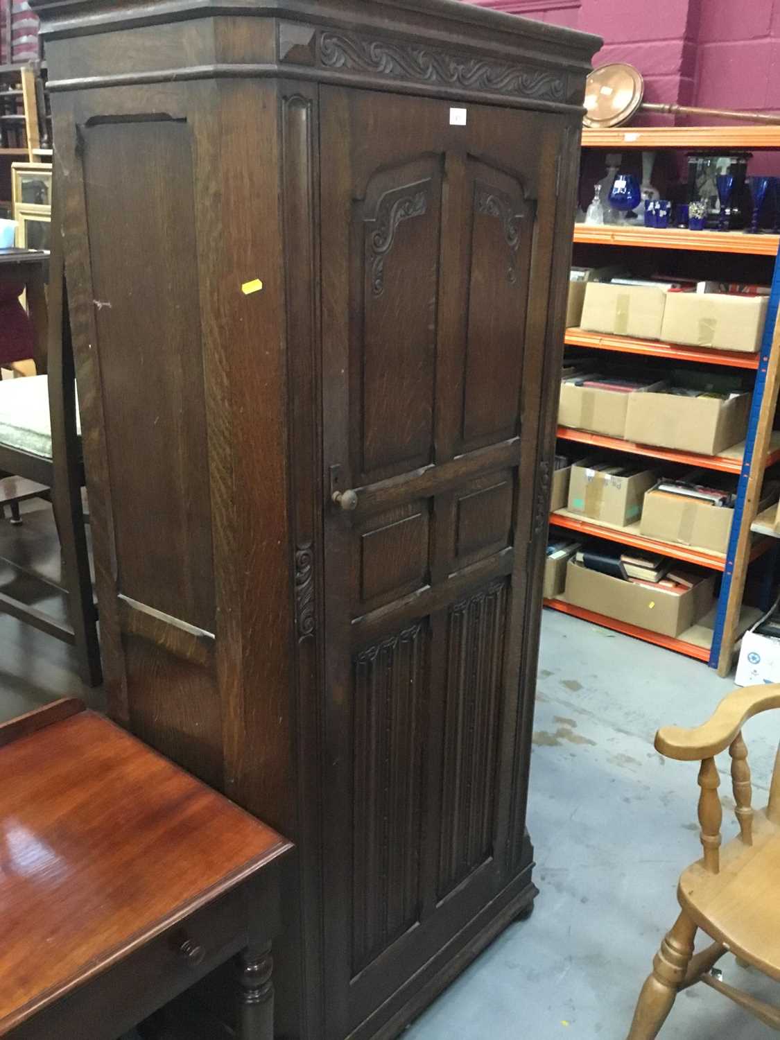 Lot 971 - 1950s oak hall wardrobe with linen fold decoration