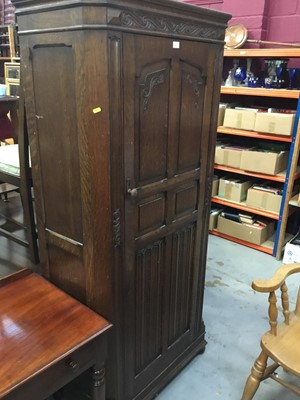 Lot 971 - 1950s oak hall wardrobe with linen fold decoration