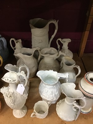 Lot 546 - Collection of Victorian relief moulded white glazed jugs, together with first period Belleek jug