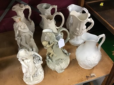 Lot 550 - Two Victorian Parian figures and collection of seven relief moulded jugs