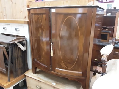 Lot 985 - Edwardian inlaid mahogany bowfront cupboard enclosed by two panelled doors