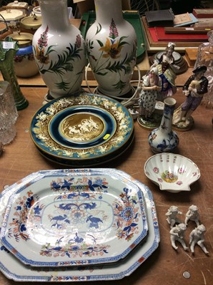 Lot 450 - Three Spode meat plates, pair majolica chargers, pair hand painted lamps, three continental figures, Limoges shell shaped dish, porcelain bottle vase and four bisque cherubs