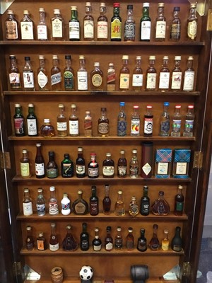 Lot 135 - Collection of miniature spirits in wall cabinet.