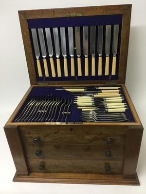 Lot 334 - Early 20th century oak three drawer canteen of cutlery and cased carving set